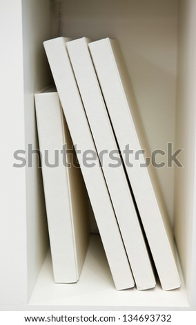 white bookshelves with white books