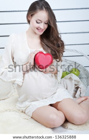 Woman pregnancy with red heart