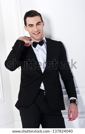 Man in black dinner jacket with bow tie. Bridegroom