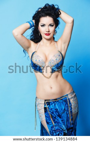 beautiful slim woman belly dancer sexy arabian turkish oriental professional artist in carnival shining costume with long healthy glossy hair. exotic star of bellydance