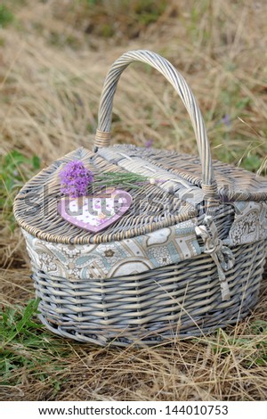 Fresh lavender with a wooden heart on a basket. Provence decor
