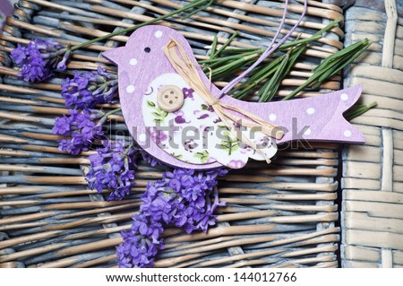 fresh lavender with a wooden bird on a basket