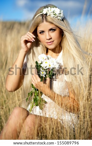 Woman with long  blond hair perfect skin. Young woman outdoors. Bride