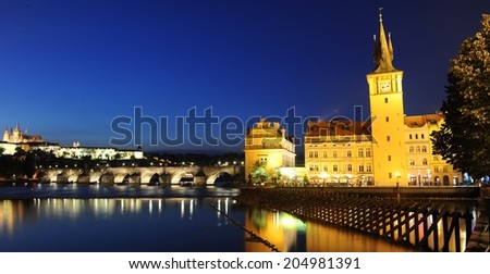 Panoramic night view to Lesser Town, Prague castle, St. Nicholas church and Charles bridge