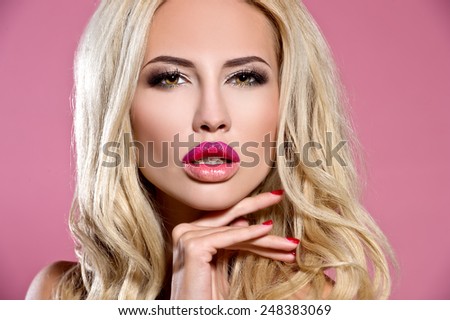 Beautiful woman with volume and shiny curly hair style, bright lips make-up