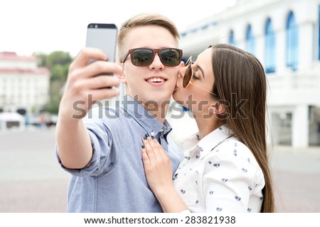 Beautiful happy smiling couple in love having fun together end enjoy their love and romantic date. Close up portrait of loving couple. Couple making selfie.