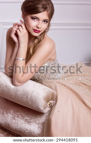 Fashion photo of beautiful sensual woman with long dark hair in luxurious sequin dress