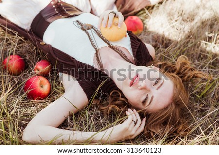 Beautiful woman clothing style boho in autumn outdoor. Woman with res apples