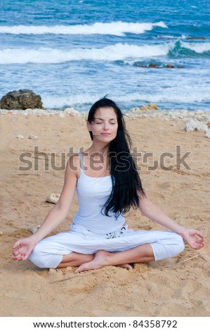 attractive brunette woman in yoga poseattractive brunette woman in yoga pose and sea