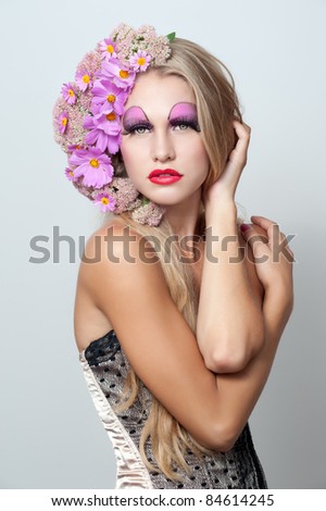 Beautiful young woman with pink flowers in hair