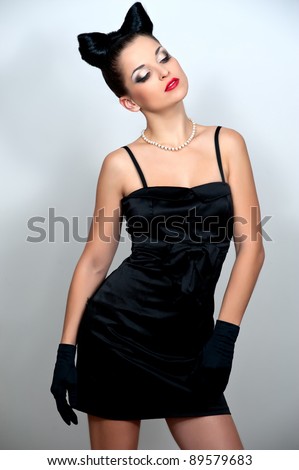 Beautiful woman with bow coiffure and black dress