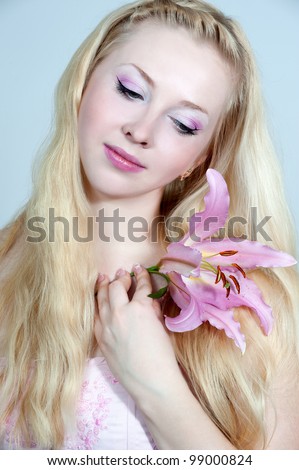 Beautiful portrait of luxury woman with fashion make-up and pink flower in hair