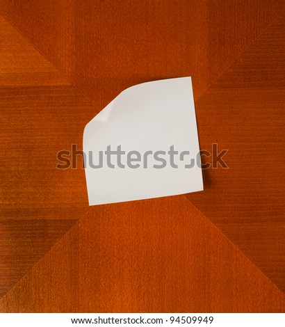 Empty paper with angled corner on wooden Background square