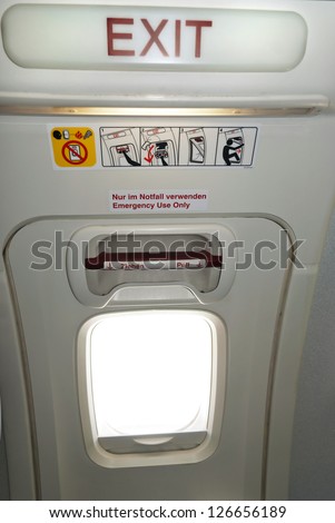 Emergency Exit In The Aircraft, Text In English And German Stock Photo ...