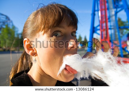 A young woman to regale with candy floss in the park