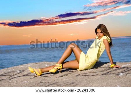 Swarthy young girl poses on the beach