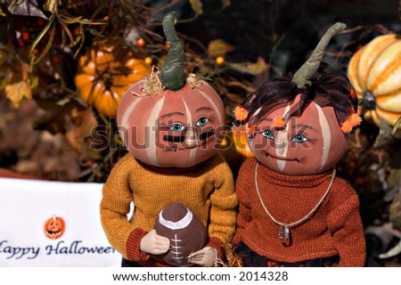 Pumpkin head doll couple dressed as foot ball fans