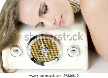 Elegant Young Beauty Listening to Love Songs on a Vintage Radio.