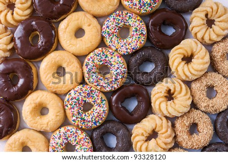 Similar – Image, Stock Photo Donuts in a row on blue background. Homemade ring doughnuts, top view