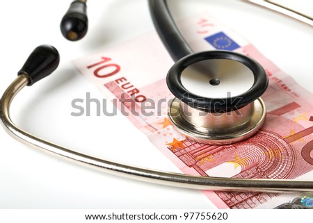 Medical stethoscope and monetary denominations of euro, close up