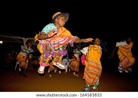 MASAKA, UGANDA - NOVEMBER 23: An unidentified dancing group performs a traditional dance during the night on November 23, 2013 in Masaka.  Dance tells the story of traditional life.