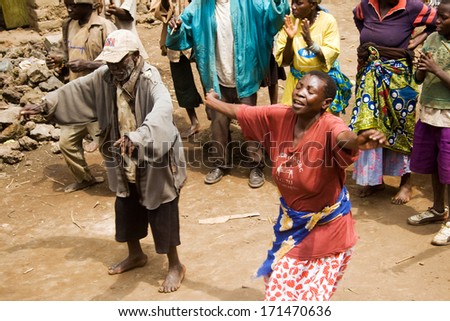 KISORO, UGANDA - DECEMBER 31, 2013: Unidentified pygmy people sing and dance in their village.