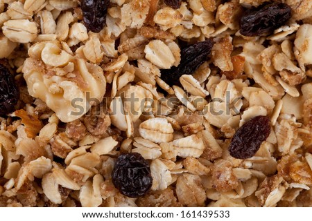 Macro shot of homemade granola with oats, almonds, organic raisins, and walnuts