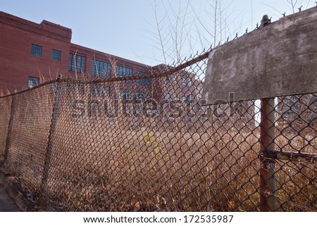 Chain link fence surrounding abandoned WWII factory
