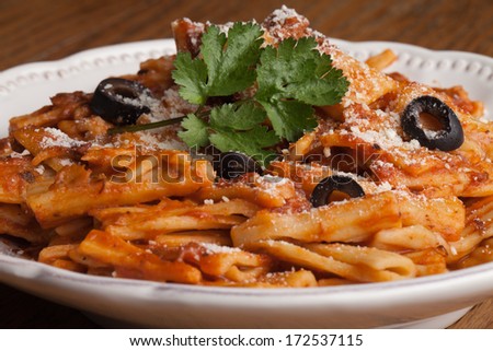 Close-up of plate of baked Rigatoni pasta with marinara sauce