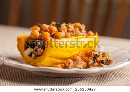 Macro shot of Delicata squash stuffed with chickpeas, kale, and onion