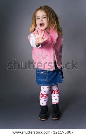 Little girl with stylish haircut emotionally put his hand forward