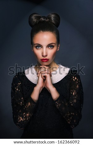 Alluring sexy woman in evening dress posing over dark background, dramatic emotion, perfect skin