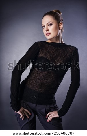 Beautiful girl in black blouse and trousers, work in studio