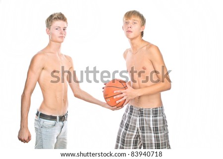 Two young guys play basketball, isolated over white