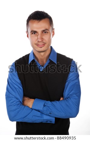 a handsome young man of business in a blue shirt and black vest,isolated over white