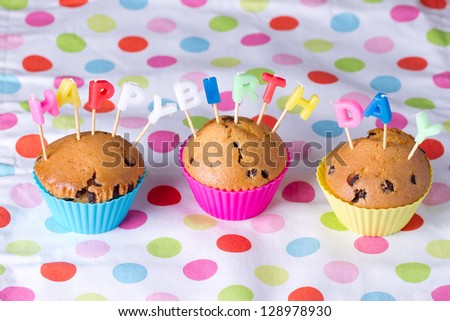 Festive  Cupcake Topped with Colorful Sprinkles and Happy Birthday Sign on White Background