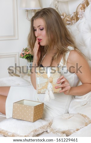 girl gifts relaxing on bed at home luxury interior