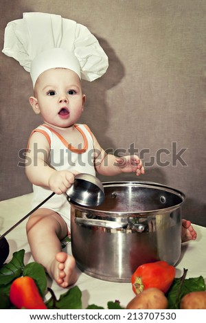 little baby in a chef\'s hat and ladle in hand