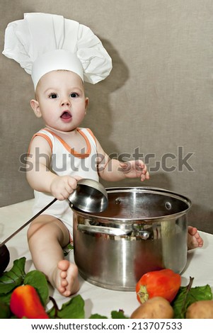 little baby in a chef\'s hat and ladle in hand