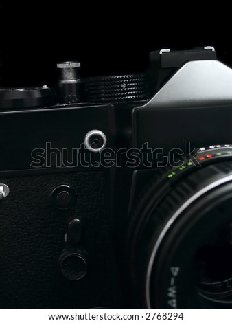 Old SLR camera isolated on black background