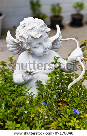 Statue of Cupid in garden