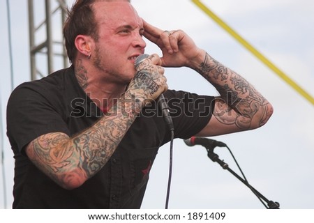 Josh Brown, frontman for the Christian rock band Day Of Fire, performs at an outdoor concert.