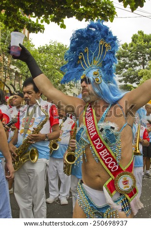 SAO PAULO, BRAZIL - JANUARY 31, 2015: An unidentified man dressed like a woman participate in the annual Brazilian street carnival dancing and singing samba.