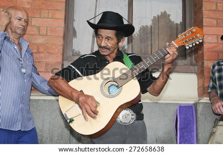 SAO PAULO, BRAZIL - MARCH 8, 2015: An unidentified group of men playing guitar and singing country musics in front of Luz Station on Sao Paulo Brazil.
