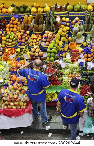 SAO PAULO/BRAZIL - MAY 9: An unidentified vendor at a fruit stand in Central Market of Sao Paulo. This landmark is a famous destination for tourists and locals.
