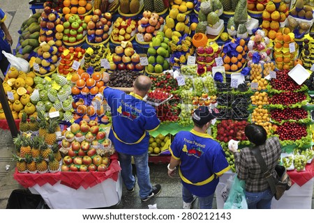 SAO PAULO/BRAZIL - MAY 9: An unidentified vendor at a fruit stand in Central Market of Sao Paulo. This landmark is a famous destination for tourists and locals.