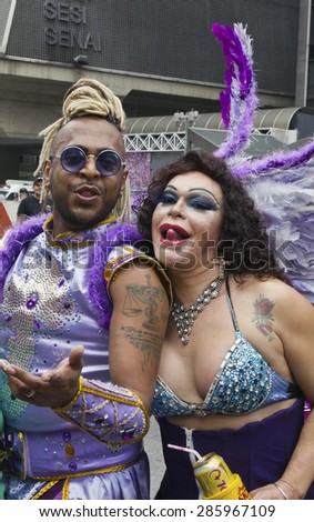 SAO PAULO, BRAZIL - June 7, 2015: Two unidentified persons  wearing costumes celebrating lesbian, gay, bisexual, and transgender culture in the 19Âº Pride Parade Sao Paulo.