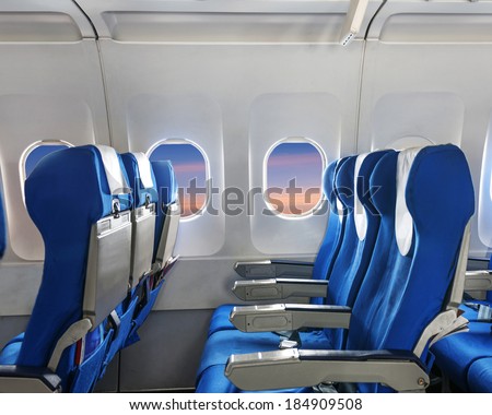 Empty aircraft seats and windows.