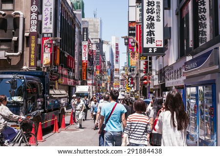 TOKYO, JAPAN -MAY20, 2015: Pedestrians walk at Shibuya Crossing during the holiday season.