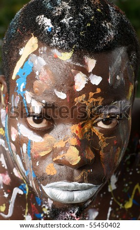 closeup of man with body paint daubed on skin